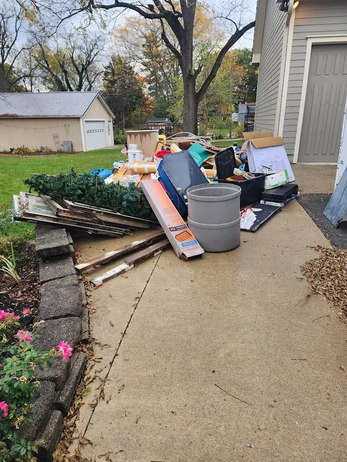 Dumpster being loaded with debris for 12 Yard Dumpster Rental in Lakemoor